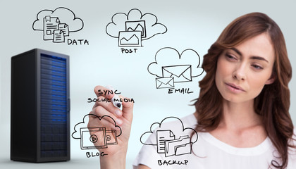 Concentrated businesswoman holding whiteboard marker against digitally generated black server tower