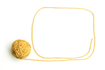 Yellow thread ball with frame made of thread isolated on white background. Cotton thread ball with...