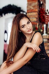 Fototapeta na wymiar Portrait of beautiful young woman with makeup in fashion clothes