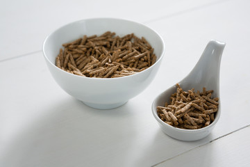 Cereal bran sticks in bowl and spoon