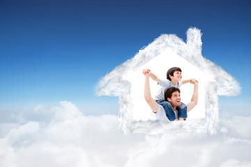 Attractive father giving a piggyback to his son against blue sky over clouds