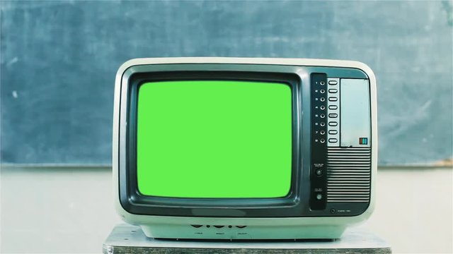 80s Television with Green Screen in a School. Dolly Out. You can replace green screen with the footage or picture you want with &ldquo;Keying&rdquo; effect in AE  (check out tutorials on YouTube).