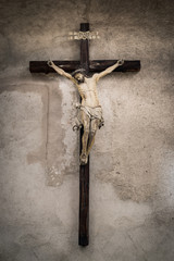Wooden crucifix hung on the wall of an old church.