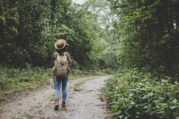 traveller women walking on road in the forest