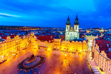 Buildings on the Old Town square Staromestska Namesti with Tyn Church in Prague during sunset, Czech Republic. World famous Prague landmarks during twilight