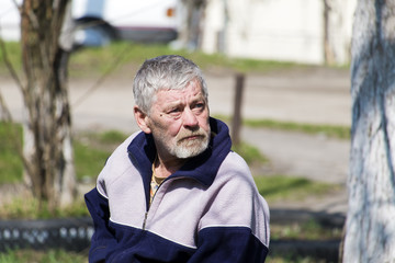 Fototapeta premium Elderly bearded man with sadness in his eyes looks up