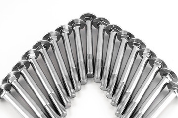 Bolts of metal for fastening parts on a white background, lined with an arc.