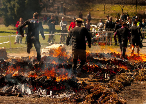 People Jumping Over Fire