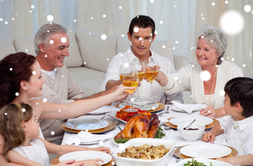 Composite image of Family toasting with wine in a dinner against snow