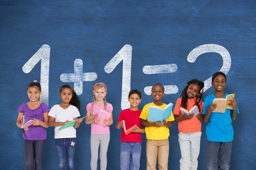 Elementary pupils reading books against blue chalkboard with maths question