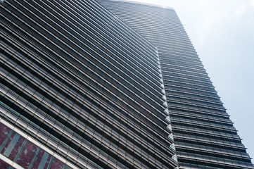 Fototapeta na wymiar Facade of modern skyscraper in Kuala-Lumpur, perspective view.