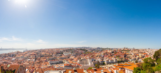 Naklejka premium Old Lisbon Portugal panorama. cityscape with roofs. Tagus river. miraduro viewpoint. View from sao jorge castle
