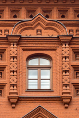 Fototapeta na wymiar Ornate window of a brick house