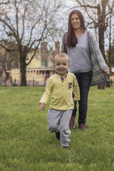 Closeup portrait of a happy mother and son playing on playground and having fun.