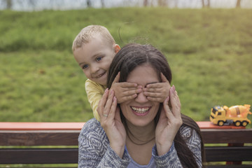 Naklejka premium Closeup portrait of a happy mother and son playing on playground and having fun.