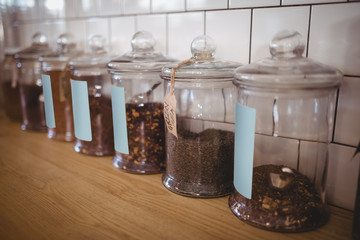 Close up of various food in glass jars with labels at coffee shop
