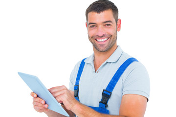Portrait of happy repairman using digital tablet