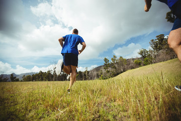 Fit man running in bootcamp