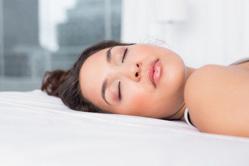 Fototapeta premium Pretty woman sleeping with eyes closed in bed