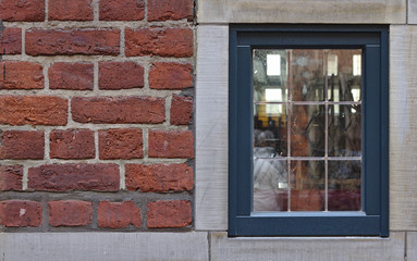 Red brick wall with antique window