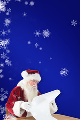 Santa reads a long list against blue