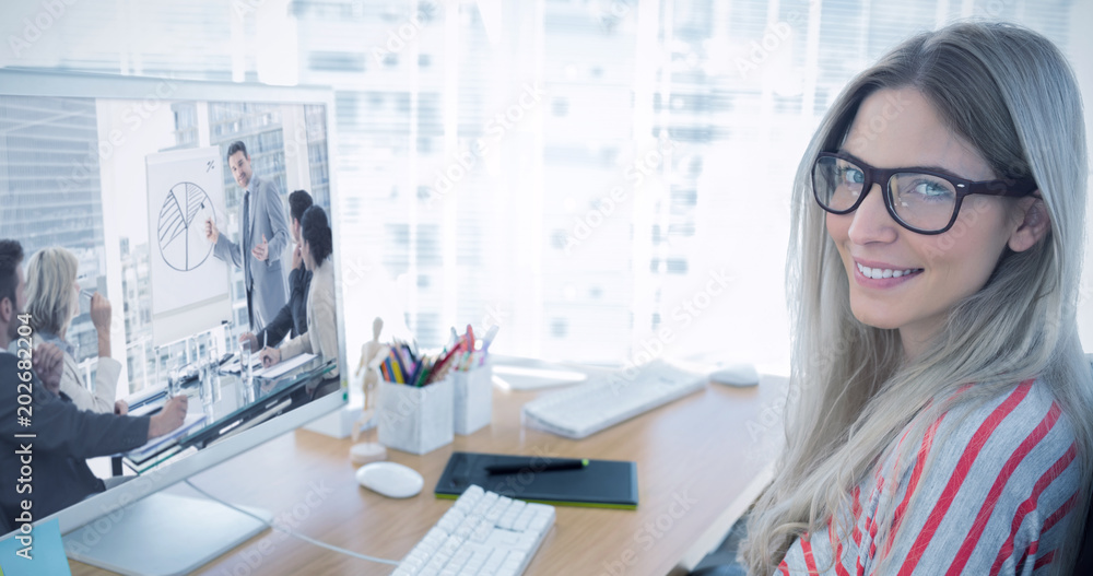 Poster attractive photo editor working on computer against business people in office at presentation