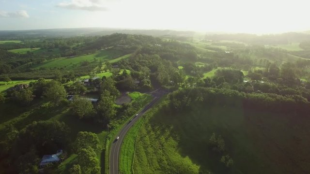 Forward flight over beautiful lush green countryside towards the sun at sunset. Brooklet, New South Wales, Australia