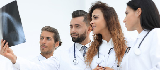 Portrait of young male doctors looking at x-ray