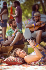 Pretty hipster relaxing on campsite