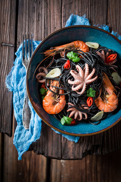 Enjoy your seafood black pasta with shrimp and octopus
