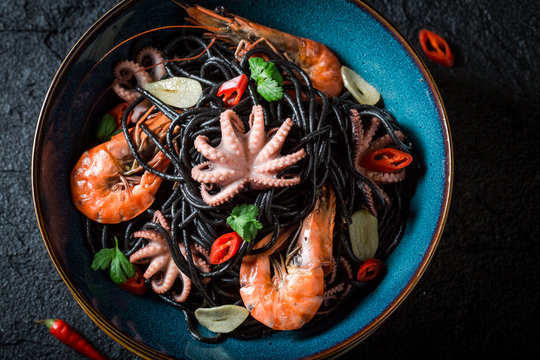 Fresh seafood black pasta made of octopus and tiger prawns