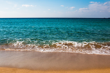 Fototapeta na wymiar Greek beach with turquoise water in a sunny day