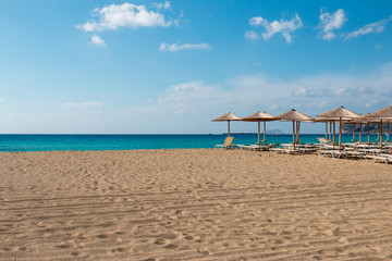 Beach sunbeds and parasols overlooking turquoise water