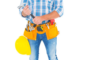 Midsection of manual worker holding hammer