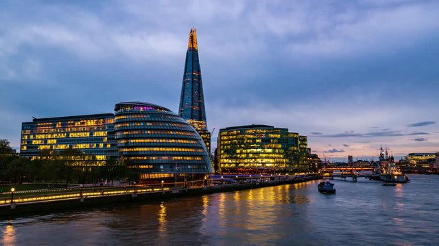 8k timelapse view of office buildings and the river Thames in London at sunset, transition into night