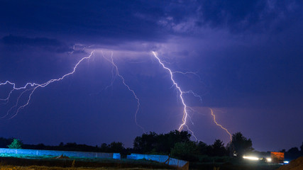 Fototapeta na wymiar Lightning strike on the dark cloudy sky