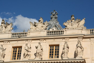 Fototapeta na wymiar Versailles palace roof decoration in sunny cloudy day