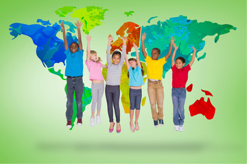 Elementary pupils jumping against green vignette with world map