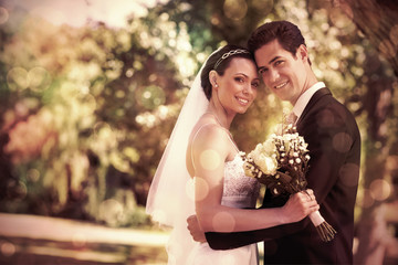 Portrait of loving newly wed couple with head to head standing in garden