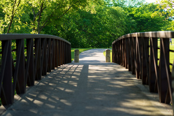 Steel pedestrian bridge in the city park on a sunny spring day in Texas