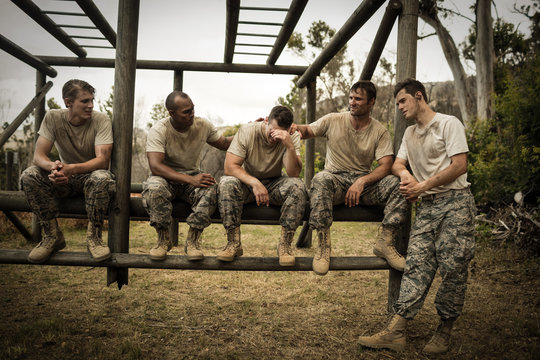 Soldiers comforting man