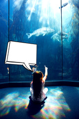 Speech bubble against little girl looking at fish tank