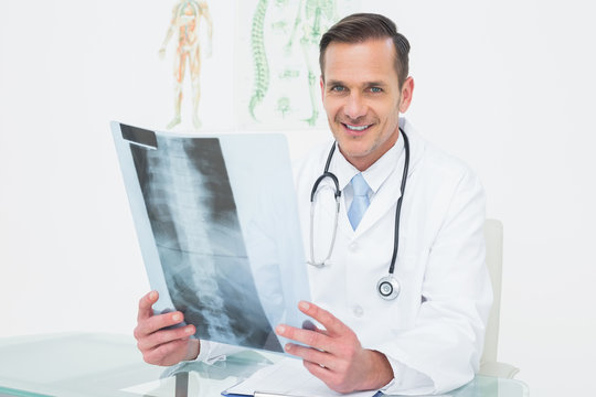 Portrait of a smiling male doctor with xray picture