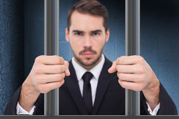 Exasperated businessman with clenched fists  against dark grey room