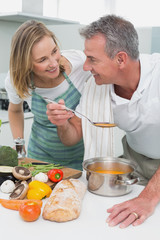 Obraz na płótnie Canvas Couple preparing food together in kitchen