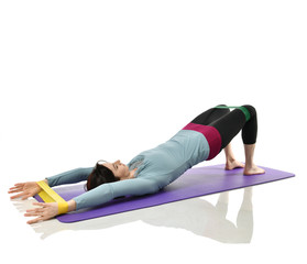 Mother woman exercising doing postnatal workout. Female fitness instructor holds legs in gym and...