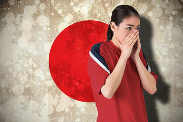 Composite image of nervous football fan looking ahead against japan flag