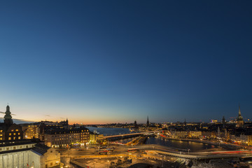 Fototapeta na wymiar Motion blurred light tracks of highway traffic to Old city (Gamla Stan) cityscape pier architecture with historic town houses in Stockholm, Sweden. Creative long time exposure landscape photography