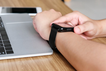 Man hand touching smartwatch, technology lifestyle concept