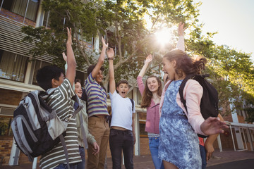 Happy school kids having fun in campus